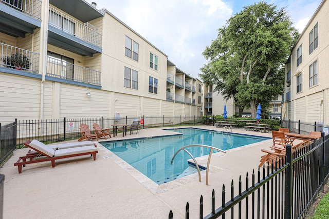 view of swimming pool with a patio area