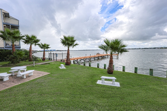 view of yard with a boat dock and a water view