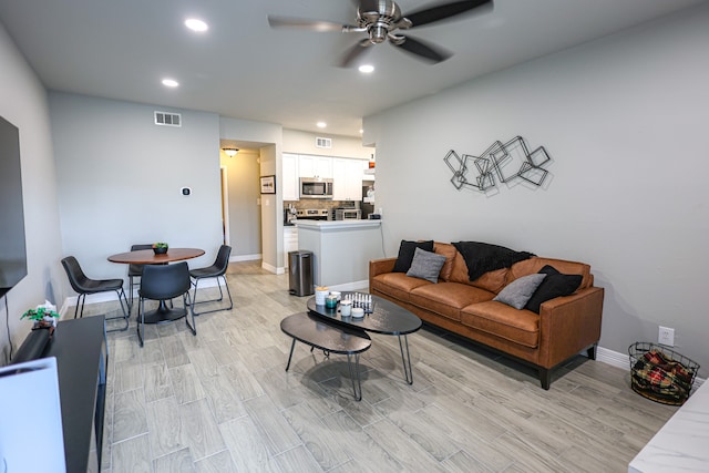 living room with ceiling fan and light wood-type flooring