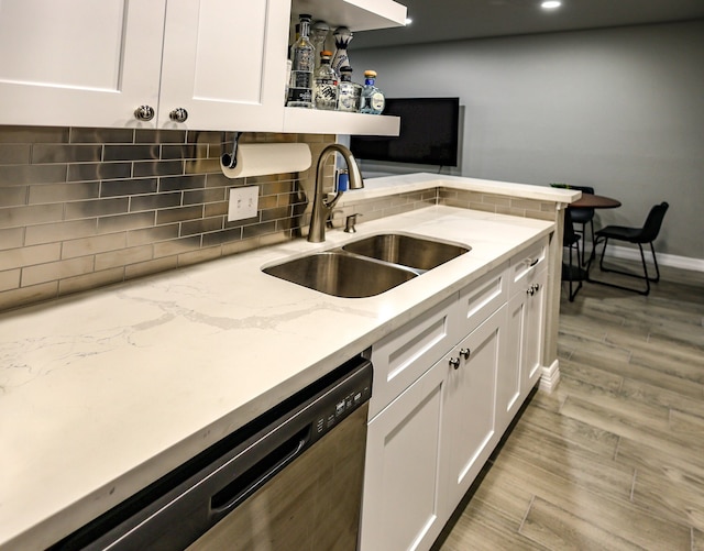 kitchen featuring dishwasher, white cabinets, light hardwood / wood-style floors, and sink