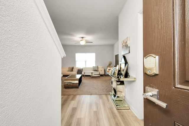 living room featuring ceiling fan and light hardwood / wood-style floors