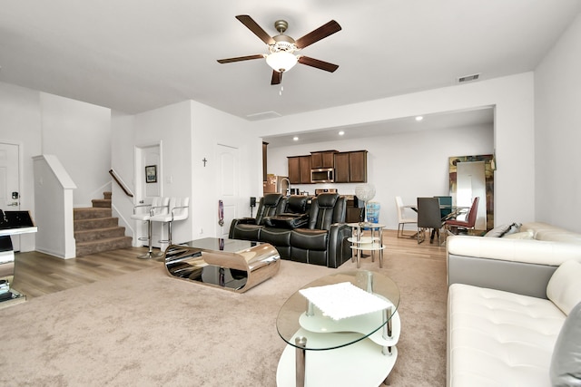 living room with ceiling fan and light hardwood / wood-style floors