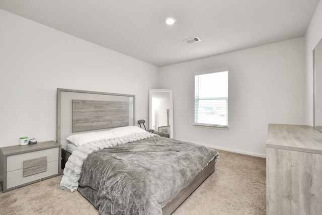 bedroom featuring light colored carpet