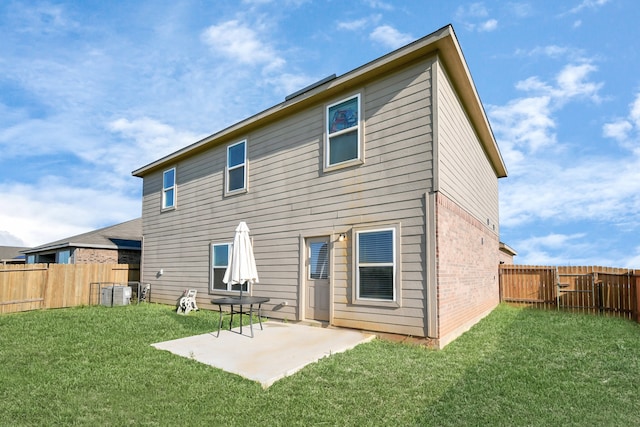 back of property featuring a yard and a patio area