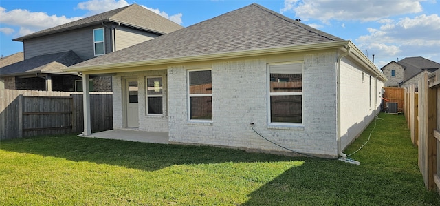 back of house with a lawn, central AC, and a patio area