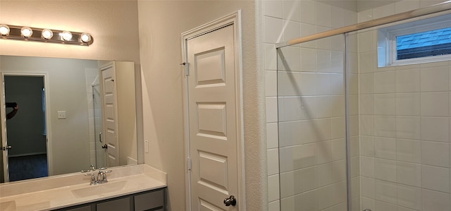 bathroom featuring vanity and a shower with shower door