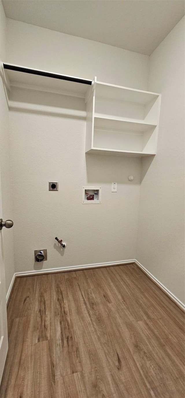21258 Catalina Palm Dr, Cypress, TX 77433 - laundry room featuring hookup for a gas dryer, hookup for an electric dryer, wood finished floors, washer hookup, and baseboards