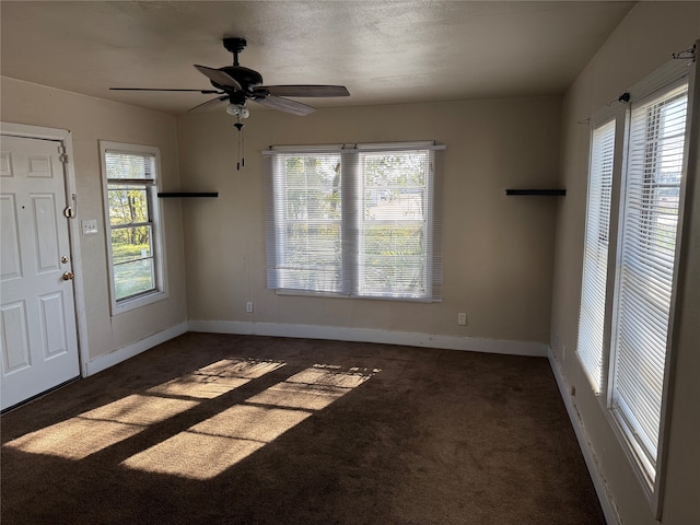 carpeted entryway featuring ceiling fan and a textured ceiling