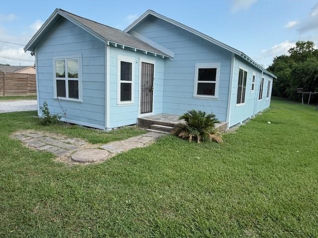 4822 W Cedar Bayou Lynchburg Rd, Baytown, TX 77521 - rear view of property featuring a lawn