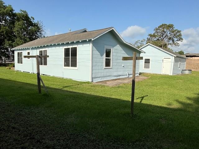 4822 W Cedar Bayou Lynchburg Rd, Baytown, TX 77521 - view of home's exterior featuring a lawn and an outdoor structure