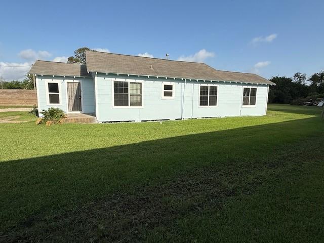 4822 W Cedar Bayou Lynchburg Rd, Baytown, TX 77521 - back of house with a lawn