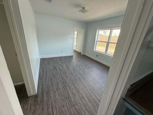 4822 W Cedar Bayou Lynchburg Rd, Baytown, TX 77521 - empty room with dark wood-type flooring and baseboards