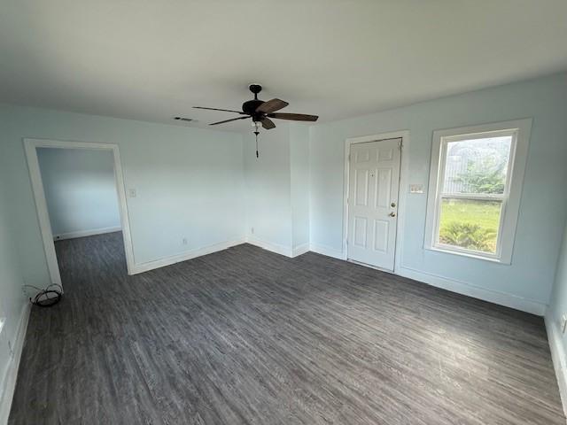 4822 W Cedar Bayou Lynchburg Rd, Baytown, TX 77521 - empty room featuring dark wood-type flooring, ceiling fan, and baseboards