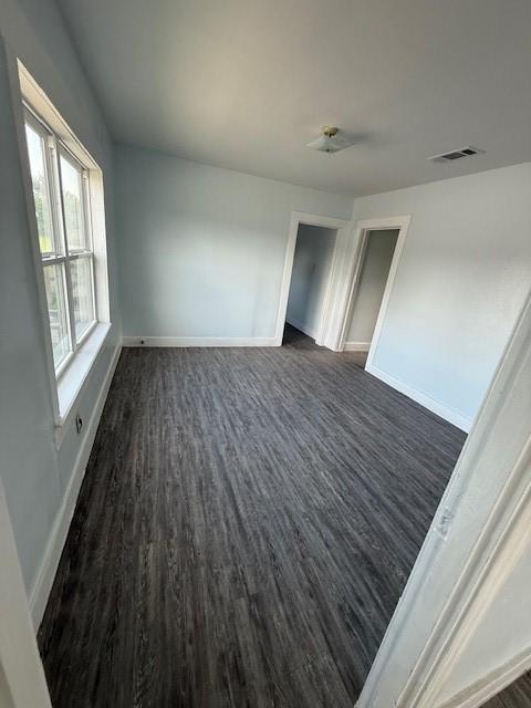 4822 W Cedar Bayou Lynchburg Rd, Baytown, TX 77521 - spare room with dark wood-type flooring, baseboards, and a ceiling fan