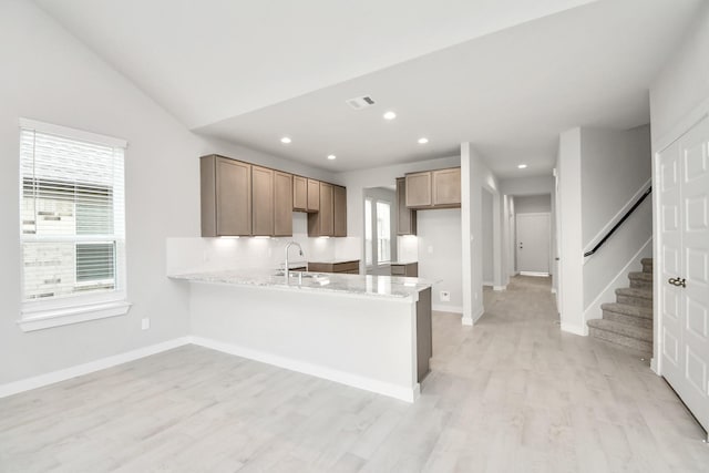 14906 Rural Ridge Rd, Cypress, TX 77429 - kitchen featuring a peninsula, light wood finished floors, recessed lighting, backsplash, and lofted ceiling