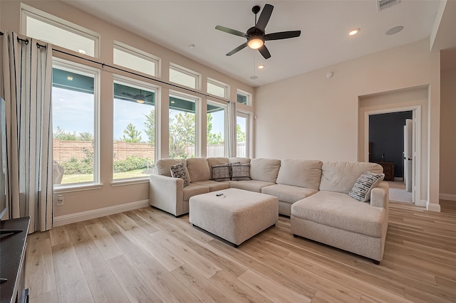 living room featuring light hardwood / wood-style flooring and ceiling fan