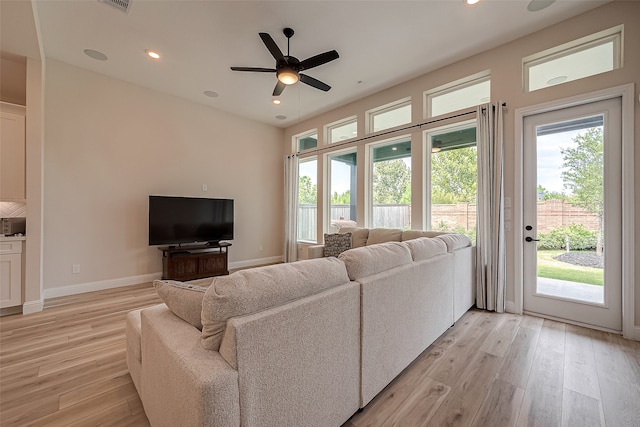 living room featuring ceiling fan and light hardwood / wood-style flooring