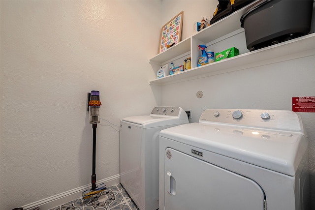 laundry area with washer and clothes dryer and tile patterned floors