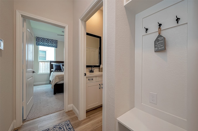 mudroom featuring light wood-type flooring and sink