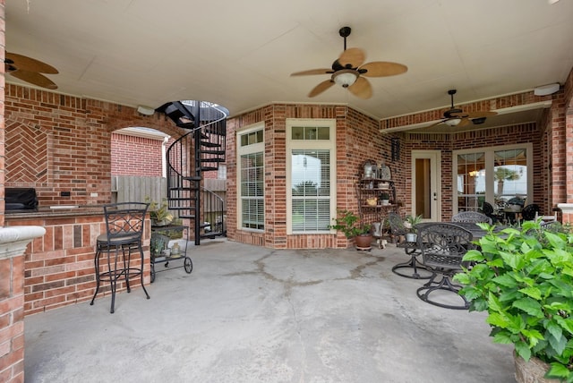 view of patio with ceiling fan and exterior bar