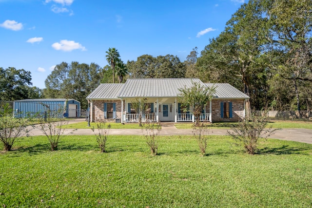 single story home with covered porch and a front yard