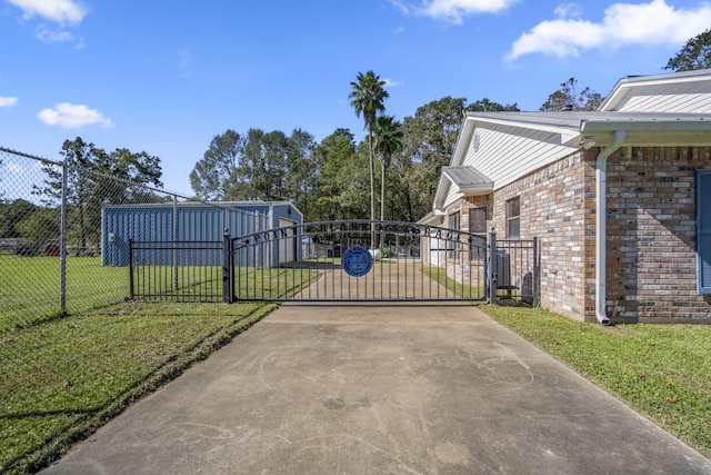 view of gate featuring a lawn