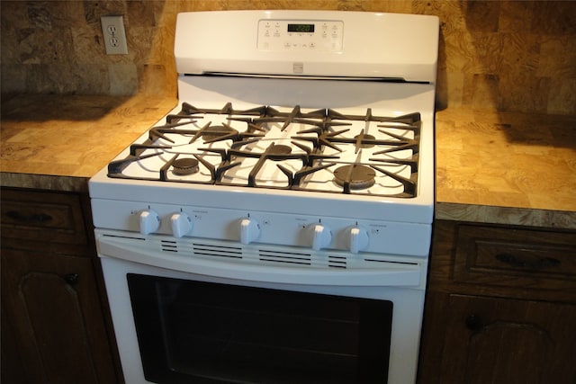 room details featuring gas range gas stove and dark brown cabinets