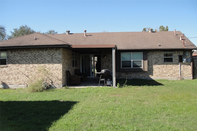 rear view of house with a yard and a patio area