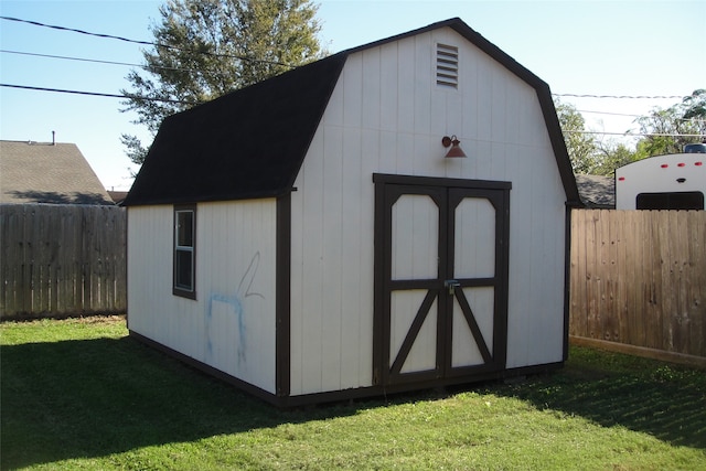 view of outbuilding with a lawn