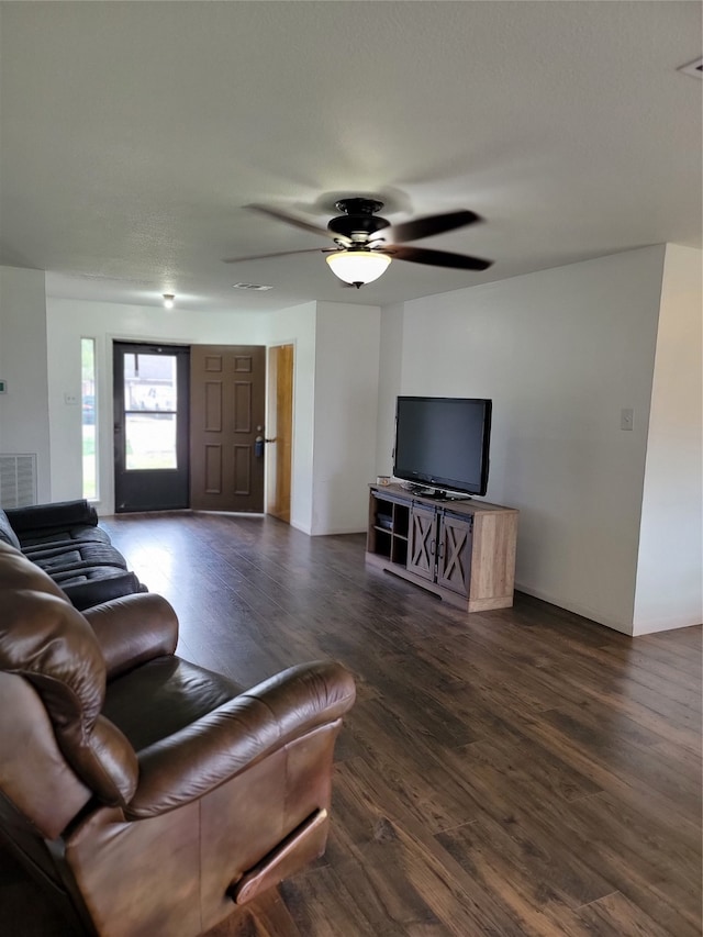 living room featuring dark hardwood / wood-style floors and ceiling fan