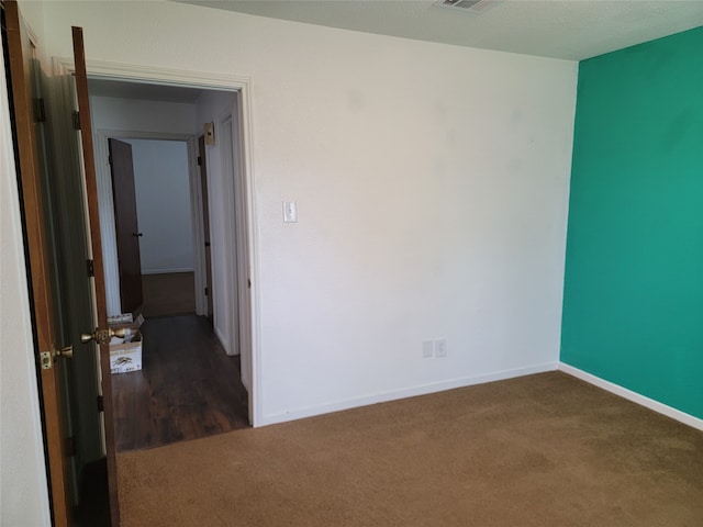 empty room with dark carpet