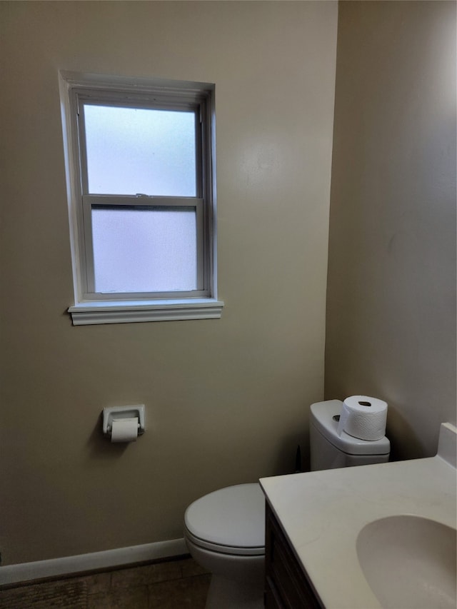 bathroom with tile patterned flooring, vanity, and toilet