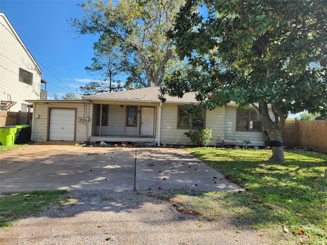 view of front of property with a porch, a garage, and a front lawn