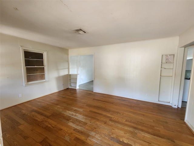 spare room with hardwood / wood-style floors