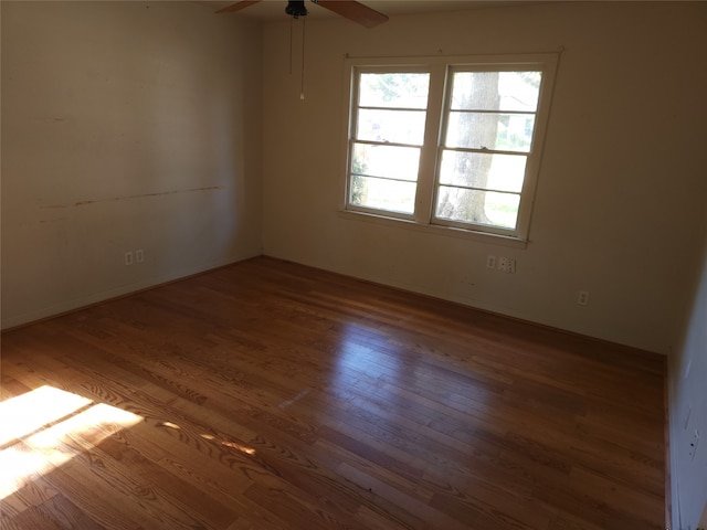 empty room featuring wood-type flooring and ceiling fan