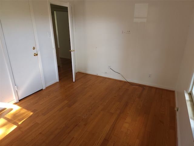 unfurnished bedroom with hardwood / wood-style flooring