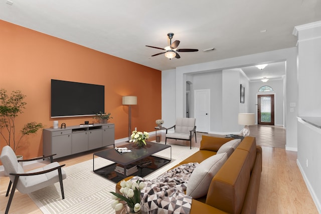 living room with light hardwood / wood-style floors and ceiling fan