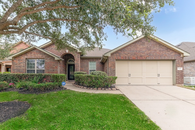 ranch-style house with a garage and a front yard