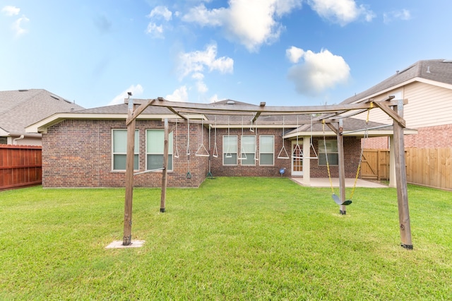 rear view of property with a patio and a lawn