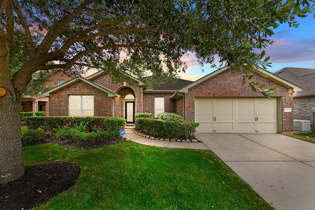 ranch-style house featuring a lawn and a garage