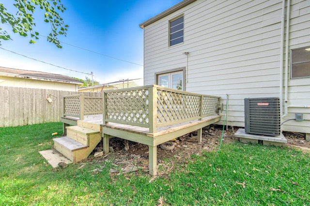 deck featuring a lawn and cooling unit