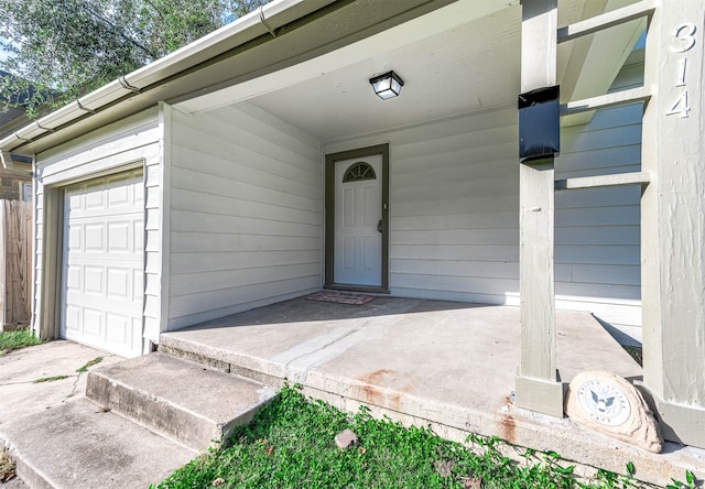 view of exterior entry featuring a garage