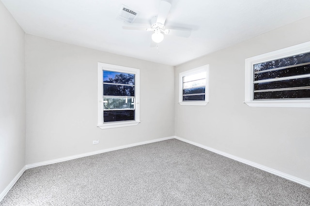 empty room with ceiling fan and carpet