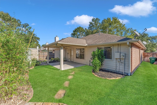 rear view of house with a lawn, ceiling fan, and a patio area