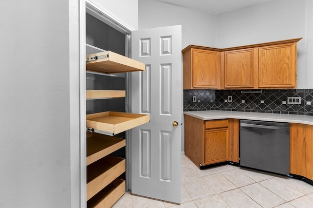 kitchen with decorative backsplash, dishwasher, and light tile patterned flooring