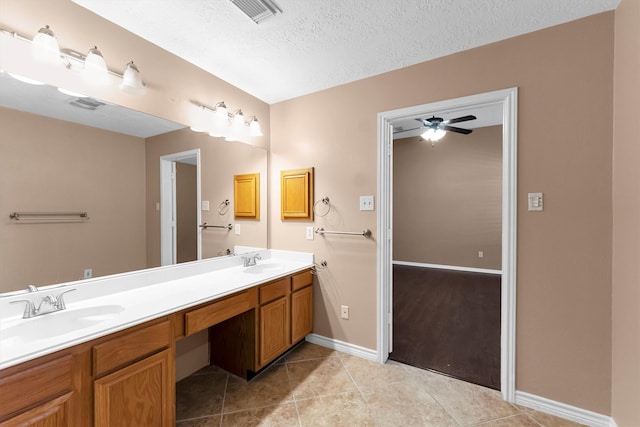 bathroom featuring tile patterned floors, ceiling fan, a textured ceiling, and vanity