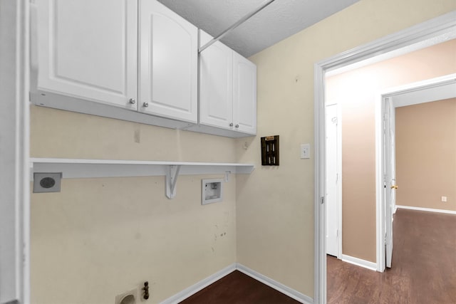 clothes washing area with electric dryer hookup, cabinets, washer hookup, and dark hardwood / wood-style floors