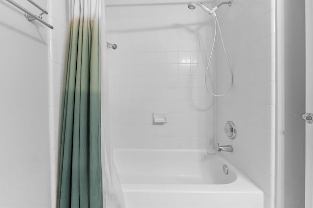 bathroom with shower / tub combo with curtain