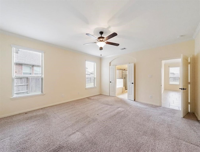 unfurnished room featuring light colored carpet, ceiling fan, and ornamental molding