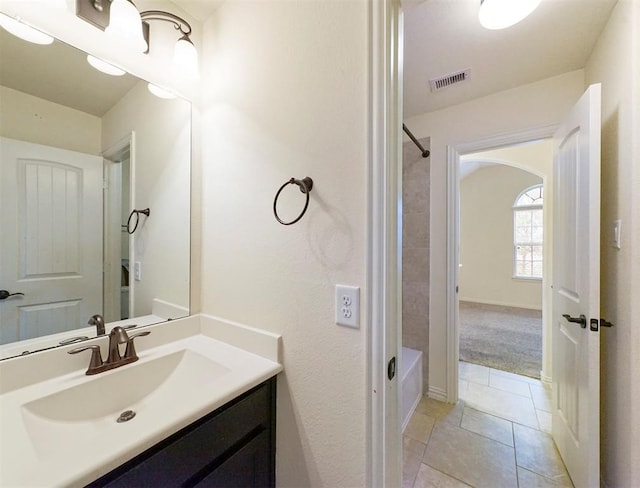 bathroom with shower / bathing tub combination, tile patterned flooring, and vanity